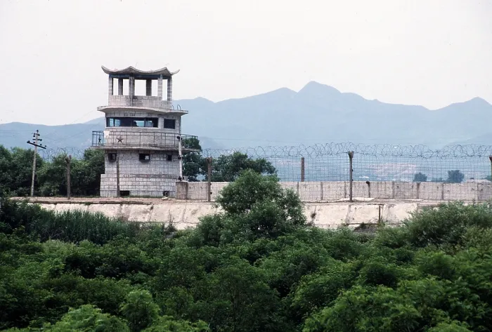 Framed Print : North Korean guard tower decorated with a Communist red star on the wall and barbed wire separating South Korea from North Korea
