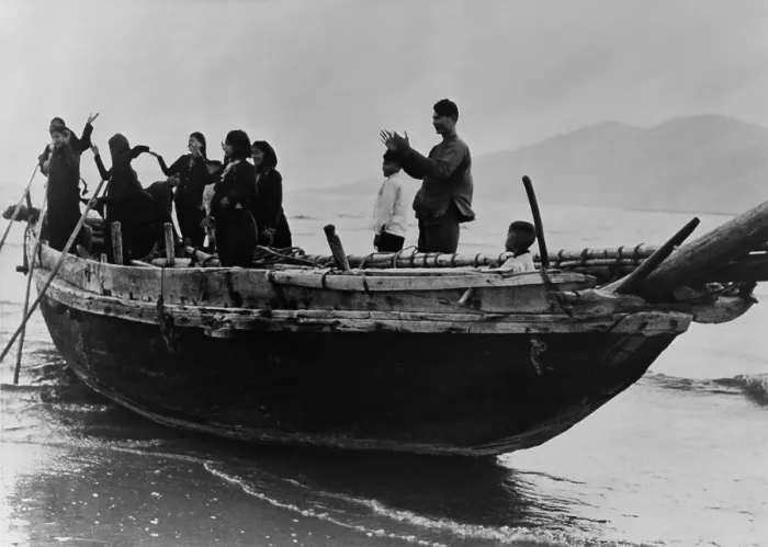 Framed Print : North Vietnamese refugees arrive at Da Nang, South Vietnam. Standing in a fishing boat, they applaud as they reach safe harbor in Tourane (Da Nang), South Vietnam. 1957 Framed Print : North Vietnamese refugees arrive at Da Nang, South Vietnam. Standing in a fishing boat, they applaud as they reach safe harbor in Tourane (Da Nang), South Vietnam. 1957