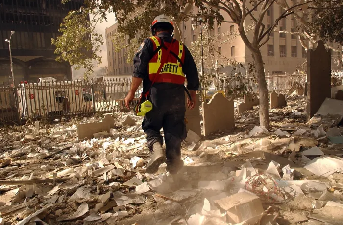 Framed Print : NYC firefighter walks among the old headstones at Trinity Church Cemetery in lower Manhattan. Sept. 19, 2001