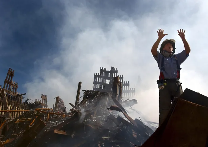 Framed Print : NYC Fireman signals for 10 more rescue workers to come into the rubble of the Ground Zero. Sept. 15, 2001