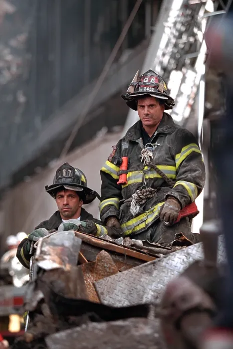 Framed Print : NYC Firemen, grim and geared for rescue / recovery work at the destroyed World Trade Center, NYC. They have a high seat to view President George W