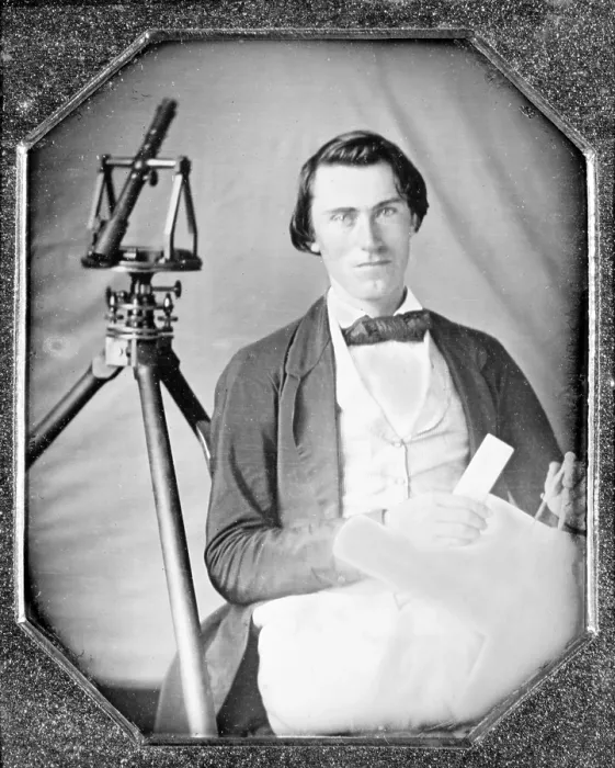 Framed Print : Occupational portrait of an unidentified surveyor with a transit on a tripod and holding dividers and a map. sixth plate daguerreotype, ca. 1840-1860