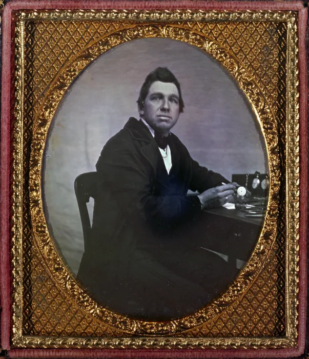 Framed Print : Occupational portrait of a watchmaker, seated at table with watches. sixth plate daguerreotype ca. 1840-1860 Framed Print : Occupational portrait of a watchmaker, seated at table with watches. sixth plate daguerreotype ca. 1840-1860