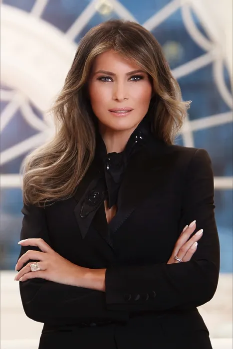 Framed Print : Official photo of First Lady Melania Trump, in the White House residence. She stands with her arms crossed, smiling, and looking into the camera, with slight smile on her face Framed Print : Official photo of First Lady Melania Trump, in the White House residence. She stands with her arms crossed, smiling, and looking into the camera, with slight smile on her face