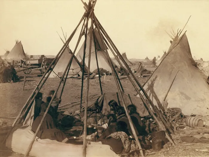 Framed Print : Oglala Sioux women and children inside an uncovered tipi frame near Pine Ridge Agency, Jan. 1891