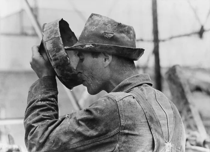 Framed Print : Oil field worker drinking water from a crude metal container, Kilgore, Texas. 1939 Photo by Russell Lee