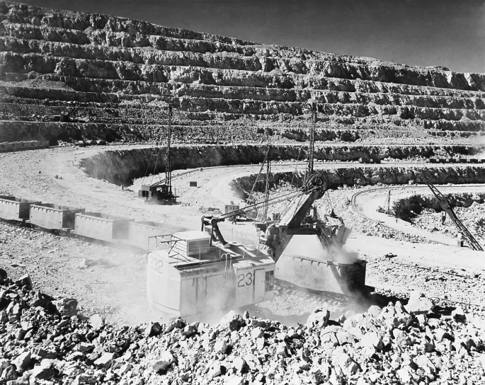 Framed Print : Open pit copper mine at Chuquicamata, Chile. Photo shows a crane steam shovel strip mining raw copper ore and depositing it into open railroad cars. Ca. 1945