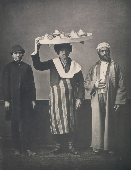 Framed Print : The Ottoman Empire, studio portrait of models wearing clothing from Istanbul, Bourgeois Muslim man of Constantinople in Europeanized dress, servant carrying tray on head Framed Print : The Ottoman Empire, studio portrait of models wearing clothing from Istanbul, Bourgeois Muslim man of Constantinople in Europeanized dress, servant carrying tray on head