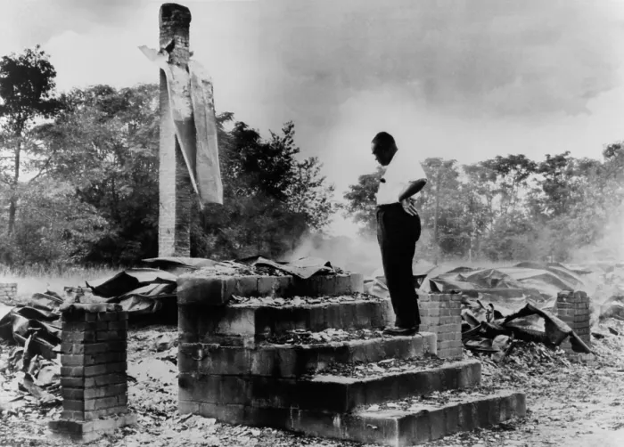 Framed Print : Pastor H.C. McClain looking over the burned ruins of his High Hope Baptist Church, Dawson, Georgia
