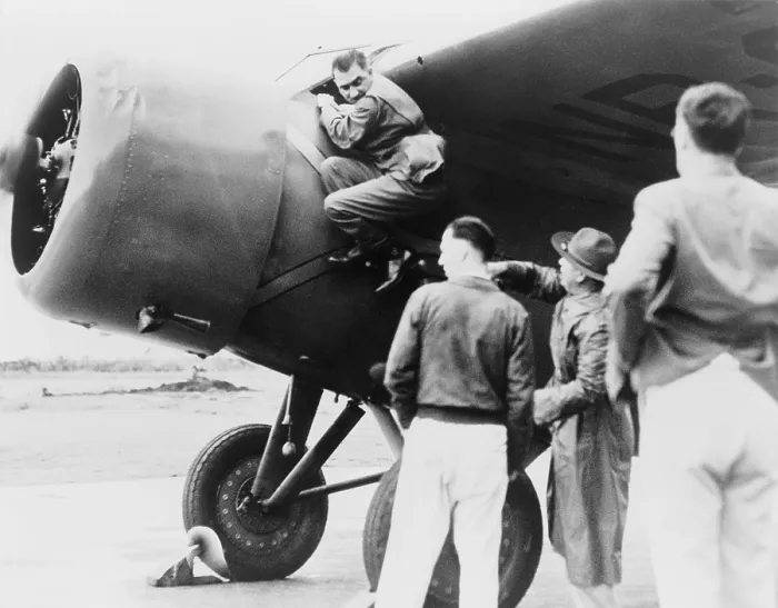 Framed Print : Paul Mantz, stunt pilot and air racer, served as Amelia Earhart's technician for her Hawaii to Oakland flight, climbing down after starting her plane at Wheeler Field Framed Print : Paul Mantz, stunt pilot and air racer, served as Amelia Earhart's technician for her Hawaii to Oakland flight, climbing down after starting her plane at Wheeler Field