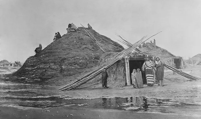 Framed Print : Pawnee lodges at Loup, Nebraska, with an Indian family standing in front of the entrance. 1873 photo by William H. Jackson