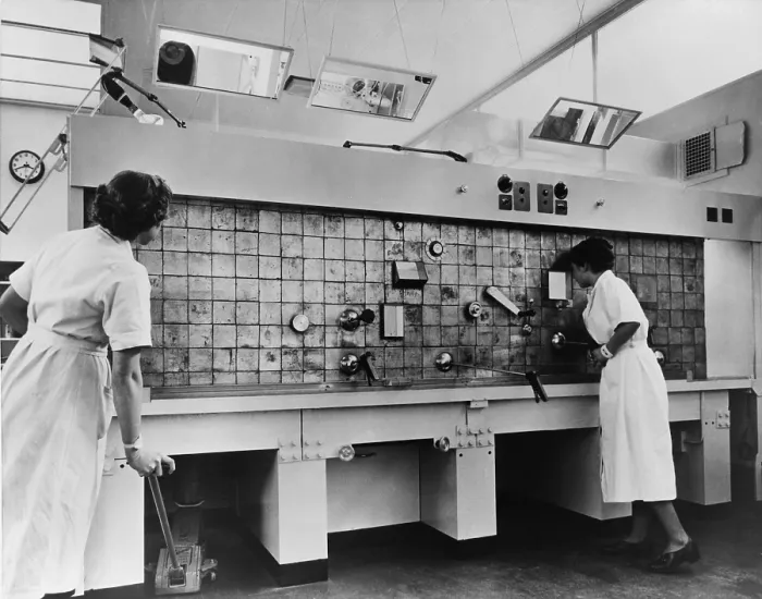 Framed Print : Peaceful use of atom. Two female technicians prepare radioactive isotopes for medical and industrial use