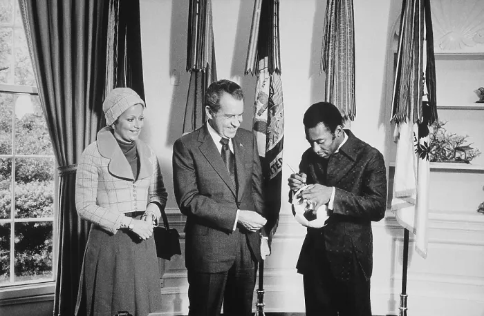 Framed Print : Pele signs a soccer ball for President Nixon as his wife Rosemeri watches. At the time Pele Director of the International Soccer Program sponsored by PepsiCo. May 8 1973