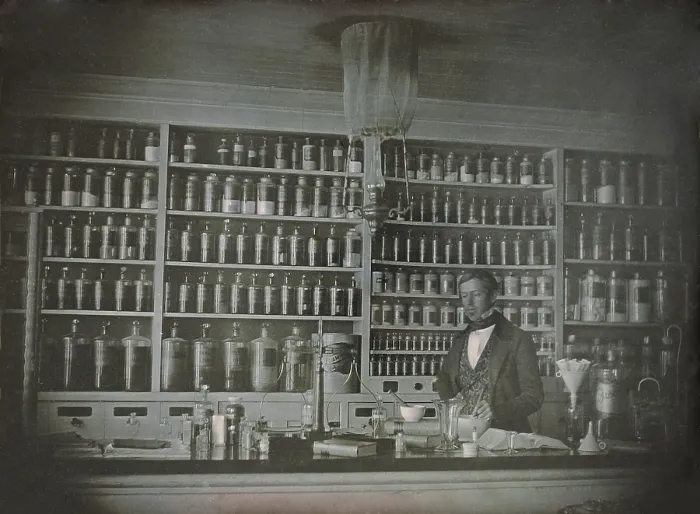 Framed Print : Pharmacist posing in his business, the S. P. Peck Apothecary, possibly in Bennington, Vermont. The photo was likely taken between 1845-1860, by an itinerant daguerreotypist