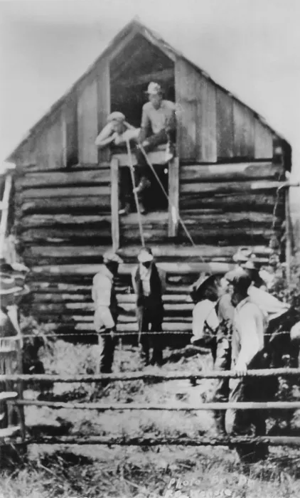 Framed Print : Photographic postcard of a few men preparing to lynch African American man by hanging from a barn