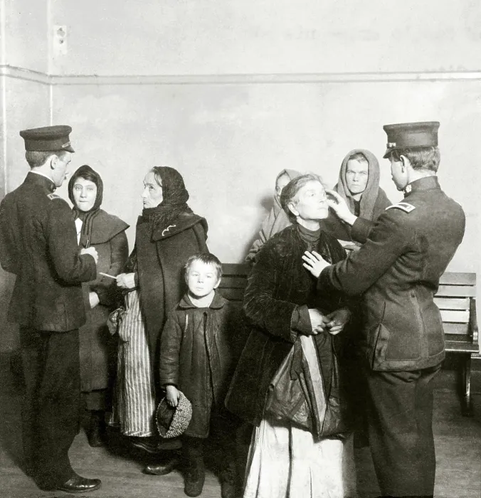 Framed Print : Physical examination of female immigrants at Ellis Island, New York City. The doctor is checking for trachoma, a highly contagious and difficult to cure eye disease. 1911