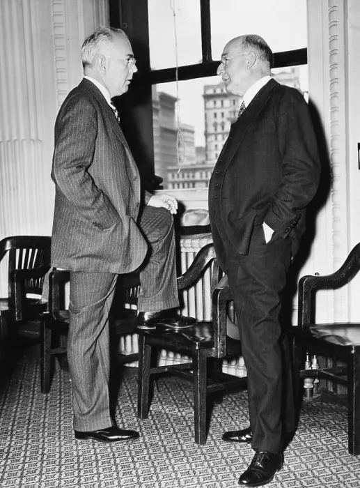 Framed Print : Pierre DuPont, noted Financier (right), talking with his lawyer, James Ivins, at a NYC hearing. May 5, 1937