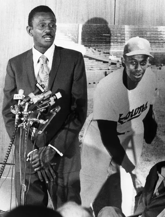 Framed Print : Pitcher Leroy Satchel Paige (1906-1982), standing beside a picture of himself as he is receiving recognition for outstanding achievements in the Negro Baseball League