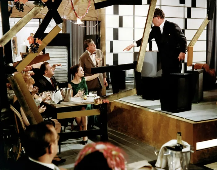 Framed Print : PLAYTIME, Barbara Dennek (raised hand), Jacques Tati (bowtie), 1967 Framed Print : PLAYTIME, Barbara Dennek (raised hand), Jacques Tati (bowtie), 1967