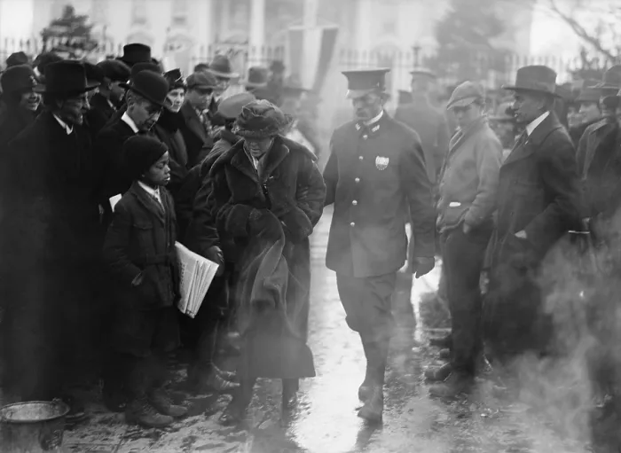 Framed Print : Policeman leads an arrested National Woman's Party protestor away from a woman's suffrage bonfire demonstration at the White House in 1918