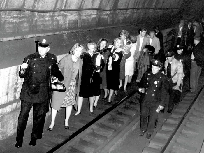 Framed Print : Policemen lead commuters through a subway tunnel. They were trapped here late on November 9th when a massive power failure stopped all trains