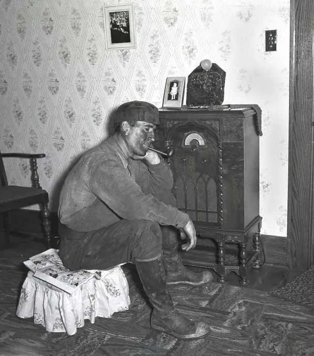Framed Print : Polish-American miner, covered with coal dust, listens to the radio after working the night shift in Westover, West Virginia. 1938 photo by Marion Post Wolcott