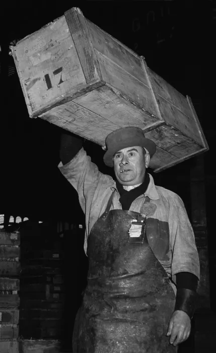 Framed Print : Porter at Paris Central Market wearing a special, narrow-brimmed, hard-crowned hat to help balance the crate of fish he is carrying on his head. 1946