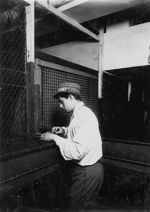 Framed Print : A Postal Telegraph boy learning to send messages during spare moments. Main office, Broadway, New York, photograph by Lewis Wickes Hine, July, 1910