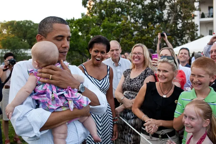 Framed Print : President Barack Obama soothes a crying baby at the Congressional Picnic