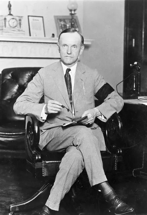 Framed Print : President Calvin Coolidge (1872-33), holding pen and paper, wearing black armband in mourning for President Harding on Aug. 4, 1923