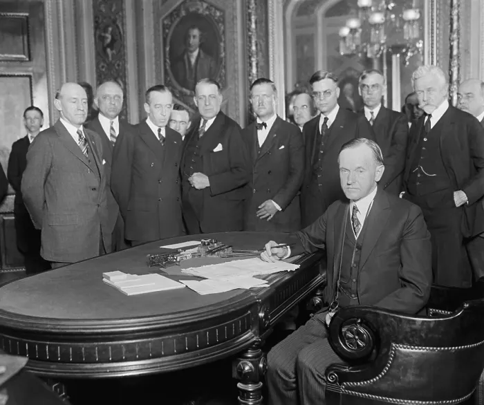Framed Print : President Calvin Coolidge signing bills at the Capitol, June 7, 1924. At right are Sen. Smoot Reed, Sen. Henry Cabot Lodge, and Speaker of the House, Rep. Nicholas Longworth