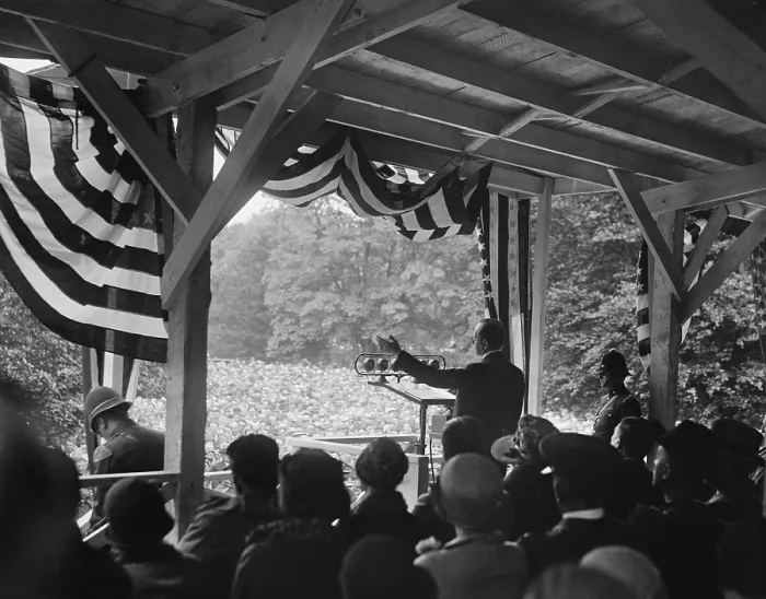 Framed Print : President Calvin Coolidge speaking to an outdoors crowd. He speaks from a bunting decorated enclosure with microphones in 1928. (BSLOC_2015_15_148) Framed Print : President Calvin Coolidge speaking to an outdoors crowd. He speaks from a bunting decorated enclosure with microphones in 1928. (BSLOC_2015_15_148)