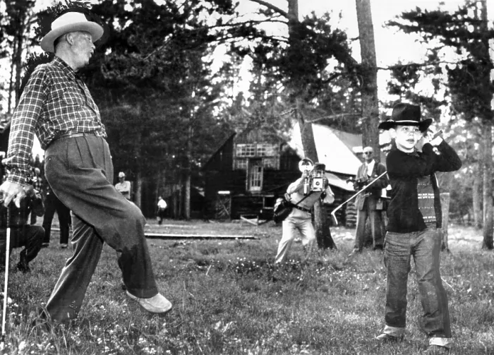 Framed Print : President Eisenhower adds a little body English to David Eisenhower's golf swing. David is being tutored in golf during a family vacation in Fraser, Colo