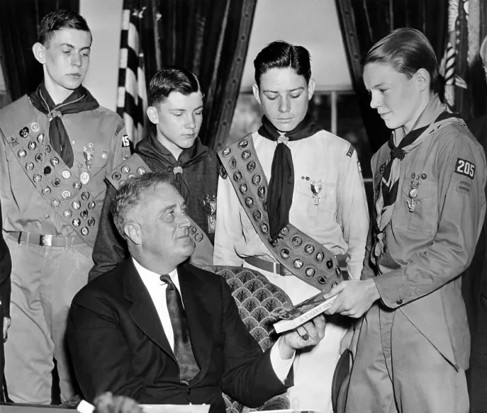 Framed Print : President Franklin Roosevelt receives the five-millionth copy of the Boy Scout Handbook. Eagle Scouts presented the special silver and green bound book to FDR on April 13, 1935 Framed Print : President Franklin Roosevelt receives the five-millionth copy of the Boy Scout Handbook. Eagle Scouts presented the special silver and green bound book to FDR on April 13, 1935