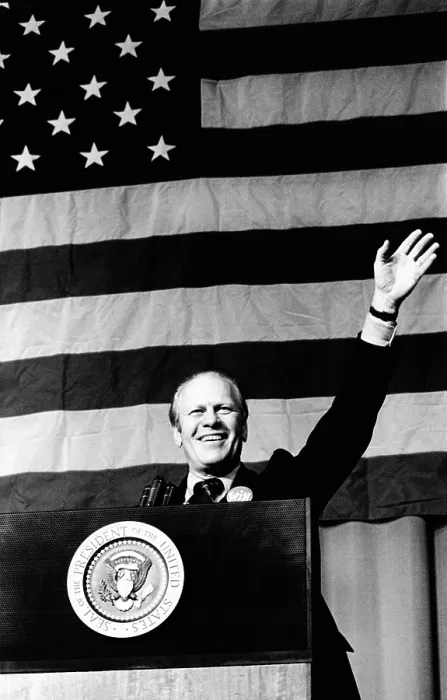 Framed Print : President Gerald Ford waves in front of a large American flag. He was speaking at a $ 100-a-couple Republican Party dinner In Indianapolis. October 16, 1974 Framed Print : President Gerald Ford waves in front of a large American flag. He was speaking at a $ 100-a-couple Republican Party dinner In Indianapolis. October 16, 1974
