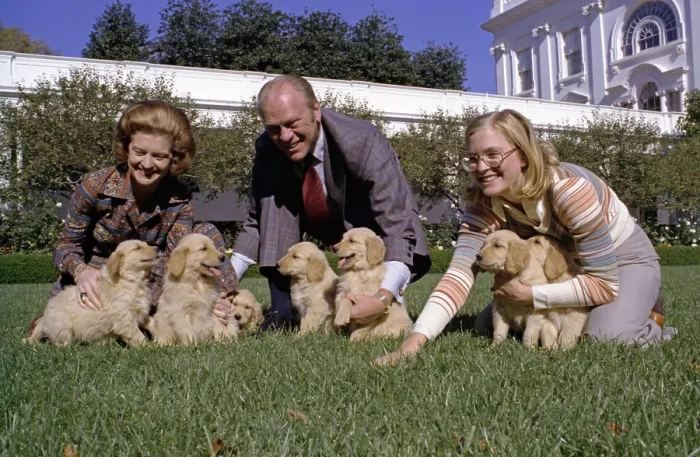 Framed Print : President Gerald Ford, wife Betty, and daughter Susan play with the new White House dogs, Liberty's golden retriever puppies, on the South Lawn of the White House Framed Print : President Gerald Ford, wife Betty, and daughter Susan play with the new White House dogs, Liberty's golden retriever puppies, on the South Lawn of the White House