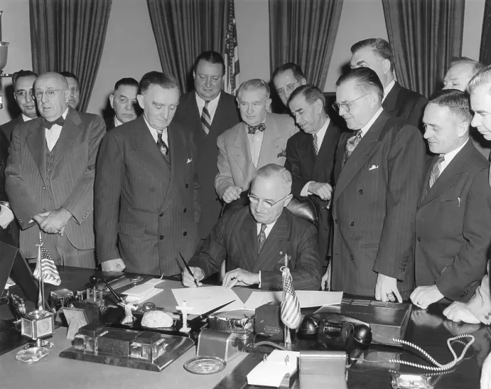 Framed Print : President Harry Truman signs act establishing Upper Colorado River Basin Compact. April 6, 1949. Four men behind Truman's chair, L-R: Interior Sec
