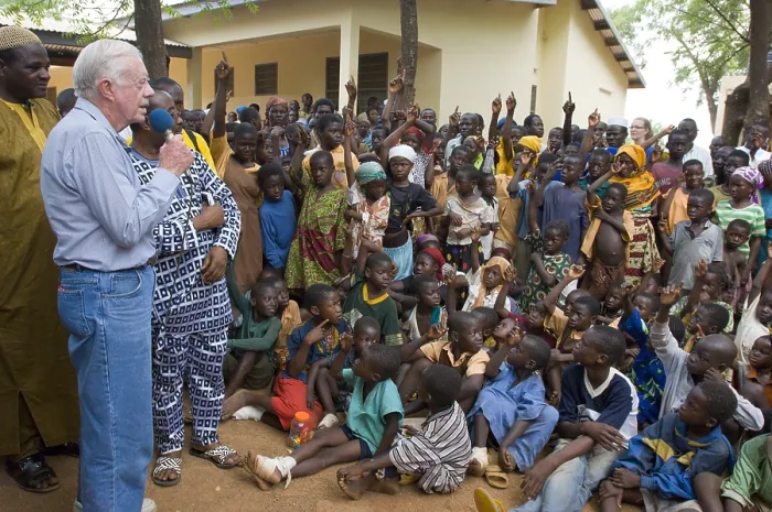 Framed Print : Former President Jimmy Carter speaks to children at Savelugu Hospital in Ghana, Feb. 8, 2007. The children with raised hands have suffered from Guinea worm disease
