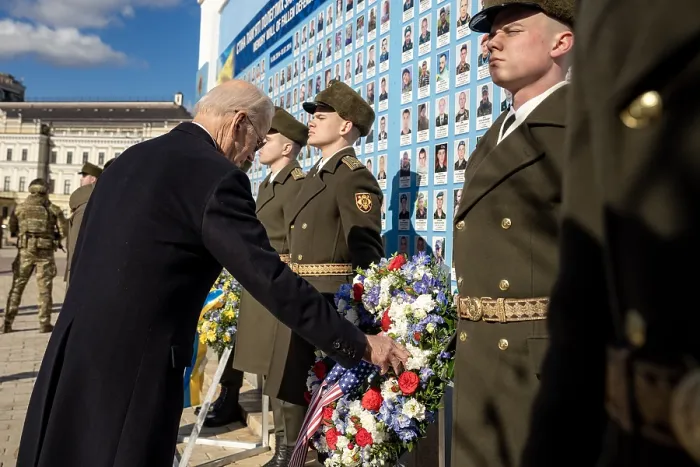 Framed Print : President Joe Biden touches a floral wreath with a US flag, at the Wall of the Fallen at St. Michael's Monastery in Kyiv, Ukraine, Feb. 20, 2023 (BSLOC_2023_6_9)
