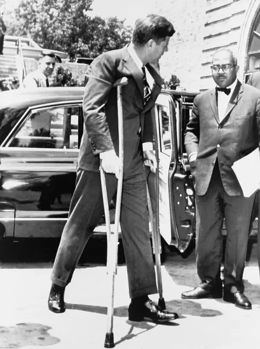 Framed Print : President John F. Kennedy on crutches accompanied by White House Press Secretary Andrew T. Hatcher on way to a conference in Washington, in June 1961 Framed Print : President John F. Kennedy on crutches accompanied by White House Press Secretary Andrew T. Hatcher on way to a conference in Washington, in June 1961