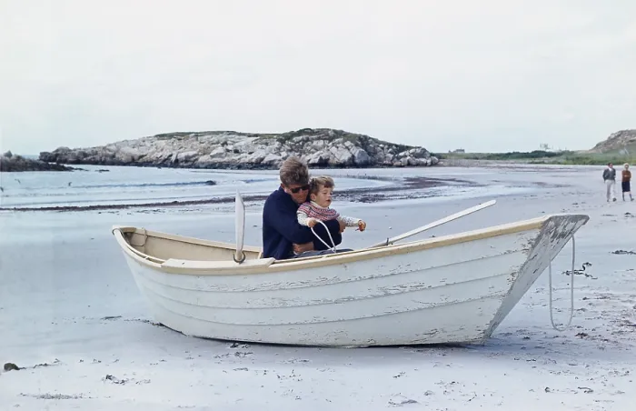 Framed Print : President John Kennedy and John Jr. play in a beached rowboat at Newport, Rhode Island. 1962