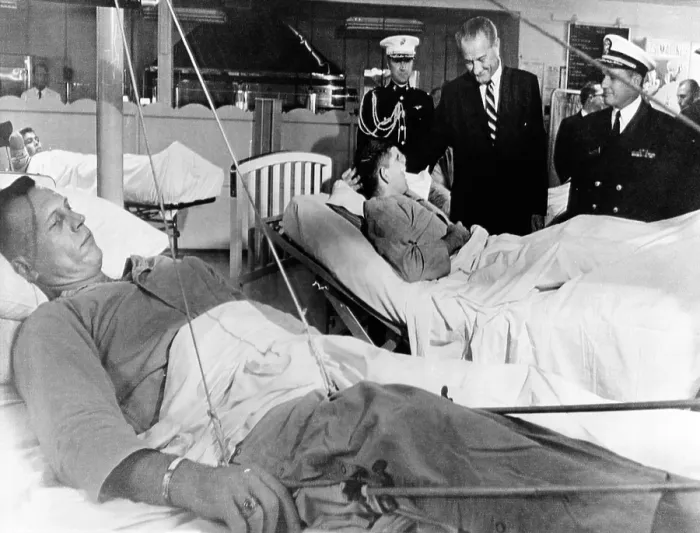 Framed Print : President Lyndon Johnson visits Vietnam wounded. Johnson chats with Cpl. Ronald Ortiz as 1st Lt. Bernard VeRonin, lying in traction in the foreground, awaits his turn