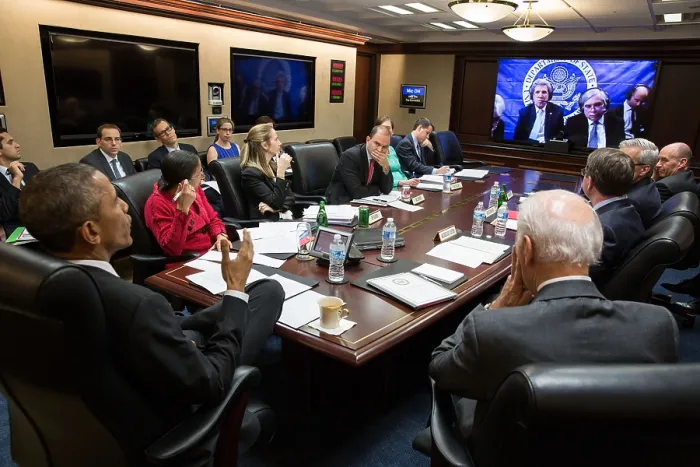 Framed Print : President Obama and National Security team in teleconference on the P5+1 negotiations with Iran. March 31, 2015. On the screen are Sec. of State John Kerry, Sec