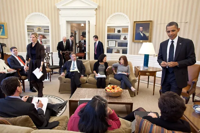 Framed Print : President Obama's staff carry in their chairs before an Oval Office meeting. Feb. 7, 2012. At left the President talks with Senior Advisor Valerie Jarrett. (BSLOC_2015_13_263)