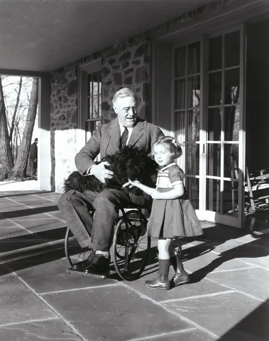 Framed Print : President Roosevelt in his wheelchair on the porch at Top Cottage in Hyde Park NY with Ruthie Bie and Fala. Photo was taken by FDR's cousin Margaret Suckley in February 1941