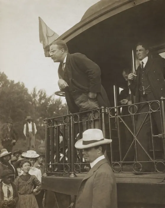Framed Print : President Theodore Roosevelt speaking to an audience which includes several African Americans. TR leans over the back of a railroad car in 1907 to emphasize important statement Framed Print : President Theodore Roosevelt speaking to an audience which includes several African Americans. TR leans over the back of a railroad car in 1907 to emphasize important statement