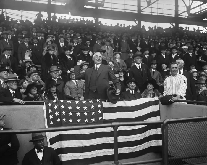 Framed Print : President Warren Harding throwing out the first ball at Washington game. Seated at left is First Lady Florence Harding