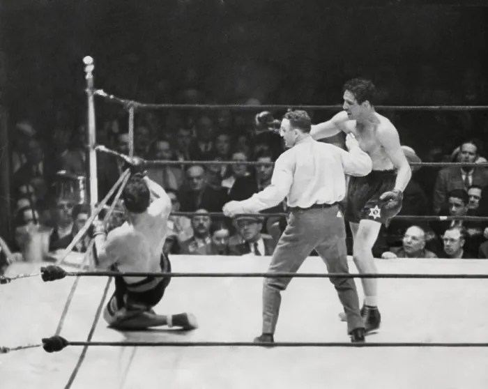 Framed Print : Primo Carnera lost his heavyweight championship to Max Baer. Photo shows Carnera on the ropes in the tenth as referee Donovan motions Baer to a neutral corner