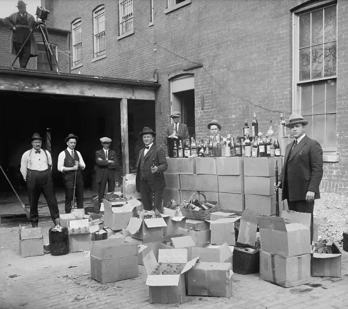 Framed Print : Prohibition agents stand with boxes and bottles of wine and liquor after a raid in Wash. D.C. area. Oct. 14, 1922. Note the camera man in upper left (BSLOC_2016_8_69)