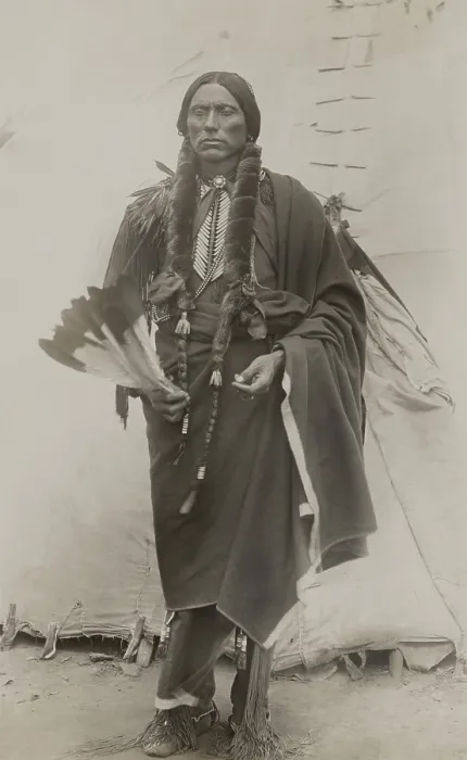 Framed Print : Quanah Parker, Principle Chief of Comanche Indians, ca. 1885, stands in front of a teepee, holding eagle feathers used in prayer